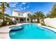 Gorgeous backyard showcasing a large swimming pool, spa, and lush tropical landscaping at 1600 Windsford Cir, Las Vegas, NV 89117