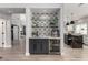 Modern bar with glass shelves, beverage fridge, and elegant tile backsplash at 1600 Windsford Cir, Las Vegas, NV 89117