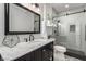 Bathroom with a black framed mirror, stylish vanity, and glass enclosed shower at 1600 Windsford Cir, Las Vegas, NV 89117