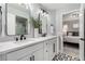 Modern bathroom featuring double vanity, a tiled shower, and views into an adjacent bedroom at 1600 Windsford Cir, Las Vegas, NV 89117