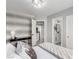 Stylish bedroom with decorative wallpaper, views into a bathroom, and contemporary decor at 1600 Windsford Cir, Las Vegas, NV 89117