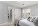 Bright bedroom with white shuttered windows, a sliding-door closet, and an ensuite bathroom at 1600 Windsford Cir, Las Vegas, NV 89117