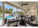 Inviting covered patio with ample seating, ceiling fans, overlooking the sparkling pool at 1600 Windsford Cir, Las Vegas, NV 89117