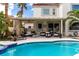 Lovely covered patio with lounge seating overlooking a sparkling blue swimming pool at 1600 Windsford Cir, Las Vegas, NV 89117