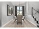 Dining room with large windows, modern chandelier, and staircase with stylish carpet runner at 1600 Windsford Cir, Las Vegas, NV 89117