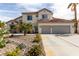 Charming two-story home featuring desert landscaping and a spacious three-car garage at 1600 Windsford Cir, Las Vegas, NV 89117