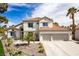 Stunning two-story home featuring desert landscaping, a two-car garage, and a tile roof at 1600 Windsford Cir, Las Vegas, NV 89117