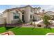 Charming two-story home featuring desert landscaping and manicured lawn at 1600 Windsford Cir, Las Vegas, NV 89117