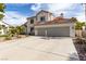 Charming two-story home featuring desert landscaping and a spacious three-car garage at 1600 Windsford Cir, Las Vegas, NV 89117