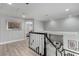 A well-lit upper hallway leading to bedrooms with a view of the living room below at 1600 Windsford Cir, Las Vegas, NV 89117