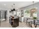 Open kitchen with modern island, stainless steel appliances, and breakfast nook at 1600 Windsford Cir, Las Vegas, NV 89117