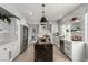 A modern kitchen with white cabinets, stainless steel appliances, and a contrasting center island at 1600 Windsford Cir, Las Vegas, NV 89117