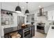 Kitchen with island, stainless steel appliances, white cabinets, and a stylish range hood at 1600 Windsford Cir, Las Vegas, NV 89117