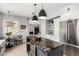 Open-concept kitchen with island, stainless appliances, and a connecting dining area at 1600 Windsford Cir, Las Vegas, NV 89117