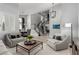 Bright living room features neutral decor, modern lighting, and an elegant staircase at 1600 Windsford Cir, Las Vegas, NV 89117
