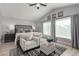 Bright main bedroom boasts vaulted ceilings, a sitting area, and large windows at 1600 Windsford Cir, Las Vegas, NV 89117
