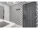 Stylish mudroom boasts patterned wallpaper, modern lighting, and sleek gray door at 1600 Windsford Cir, Las Vegas, NV 89117