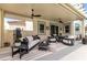Relaxing covered patio with comfortable seating and ceiling fans, perfect for entertaining at 1600 Windsford Cir, Las Vegas, NV 89117