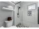 Shower featuring subway tile, a patterned tile floor, and a built-in shelf at 1600 Windsford Cir, Las Vegas, NV 89117