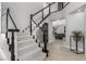 Elegant staircase with dark railing, carpeted steps, and view of the home's interior at 1600 Windsford Cir, Las Vegas, NV 89117