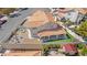 Aerial view displaying home with terracotta roof and well-appointed backyard, featuring a firepit, stock tank pool, and neat landscaping at 2021 Summit Pointe Dr, Las Vegas, NV 89117