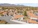 Expansive aerial view of a neighborhood showcasing well-maintained homes, beautiful landscaping, and mountain views at 2021 Summit Pointe Dr, Las Vegas, NV 89117