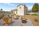 Landscaped backyard featuring gravel, Adirondack chairs around a fire pit, and a stock tank pool, creating an inviting outdoor space at 2021 Summit Pointe Dr, Las Vegas, NV 89117