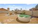 Backyard featuring a stock tank pool and a cozy fire pit area surrounded by Adirondack chairs, perfect for relaxation and outdoor fun at 2021 Summit Pointe Dr, Las Vegas, NV 89117