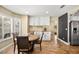 Bright dining area with updated white cabinets, stainless steel appliances and a dark countertop at 2021 Summit Pointe Dr, Las Vegas, NV 89117