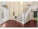 Bright foyer features a staircase and a large front door, creating a welcoming entry at 2021 Summit Pointe Dr, Las Vegas, NV 89117