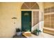 Inviting front entrance with a green door, decorative sidelights, and potted plants at 2021 Summit Pointe Dr, Las Vegas, NV 89117