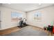 Well-lit home gym with wood flooring and ample natural light from two large windows at 2021 Summit Pointe Dr, Las Vegas, NV 89117