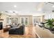 Open living room connects seamlessly to the kitchen, with a large sectional sofa and outdoor access at 2021 Summit Pointe Dr, Las Vegas, NV 89117