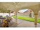 Covered patio with comfortable seating and view of the manicured backyard at 2021 Summit Pointe Dr, Las Vegas, NV 89117