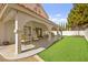 Spacious covered patio with ample seating and a view of the lush backyard at 2021 Summit Pointe Dr, Las Vegas, NV 89117