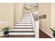 A beautifully designed staircase with wood treads and white risers adds elegance to the home at 2021 Summit Pointe Dr, Las Vegas, NV 89117