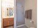 Bathroom showcasing a vanity with a mirror, a shower with glass doors, and neutral tones at 2160 Highpointe Dr # 103, Laughlin, NV 89029