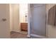 Well-lit bathroom featuring a wood-style vanity with mirror and shower with a glass door at 2160 Highpointe Dr # 103, Laughlin, NV 89029