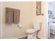 Bathroom featuring a toilet, wall art, and towel rack, connecting seamlessly to a bedroom at 2160 Highpointe Dr # 103, Laughlin, NV 89029