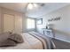 Bright bedroom with a ceiling fan, neutral walls, closet, and a large window providing natural light at 2160 Highpointe Dr # 103, Laughlin, NV 89029