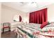 Well-lit bedroom with floral comforter, a dresser with mirror, and lots of space at 2160 Highpointe Dr # 103, Laughlin, NV 89029