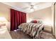 Comfortable bedroom with a floral-patterned bedspread, ceiling fan, and abundant natural light at 2160 Highpointe Dr # 103, Laughlin, NV 89029