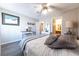 Spacious bedroom featuring wood-look flooring, ceiling fan, and a view to an adjacent bathroom and closet at 2160 Highpointe Dr # 103, Laughlin, NV 89029