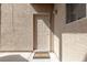Condo entrance with a welcome mat, textured walls, and stylish exterior lighting at 2160 Highpointe Dr # 103, Laughlin, NV 89029