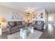 Cozy living room with neutral decor, plush sofas, and sleek laminate flooring at 2160 Highpointe Dr # 103, Laughlin, NV 89029