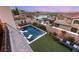 An aerial view of a backyard featuring a pool, lounge area, and lush landscaping at 258 Castellari Dr, Las Vegas, NV 89138