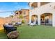 Beautiful backyard features a pool, sun loungers, artificial grass, and a comfortable seating area at 258 Castellari Dr, Las Vegas, NV 89138
