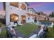 Inviting backyard with a pool, lounge chairs, patio seating, and manicured artificial grass at 258 Castellari Dr, Las Vegas, NV 89138