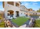 Expansive backyard with a pool, lounge chairs, lush artificial grass, and ample seating area at 258 Castellari Dr, Las Vegas, NV 89138