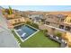 Stunning backyard featuring a pool, artificial grass, outdoor seating, and privacy walls at 258 Castellari Dr, Las Vegas, NV 89138